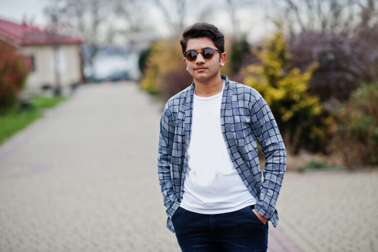 Stylish indian young man at sunglasses wear casual posed outdoor